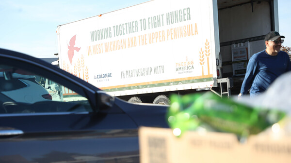 A Feeding America truck delivers food to a mobile food pantry at Holland High School.